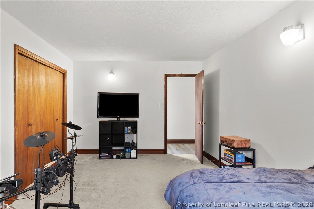 730 Slocomb Road Fayetteville, NC 28311 - Photo 32 of 48 a bedroom with a bed and a flat screen tv