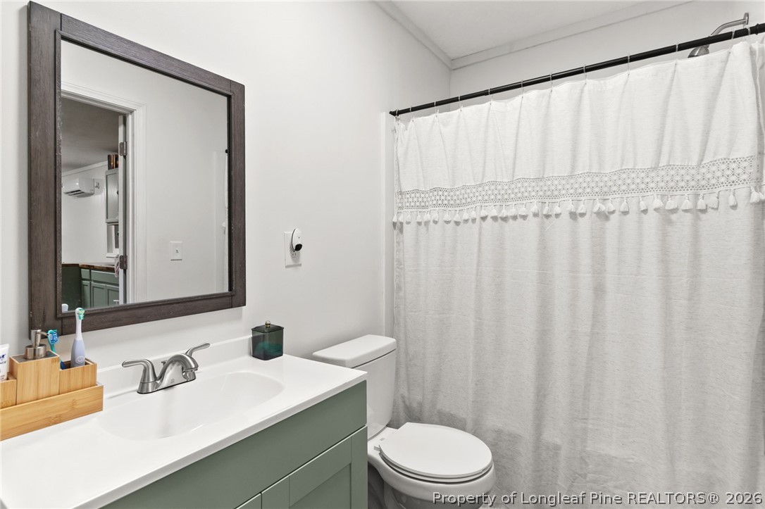 730 Slocomb Road Fayetteville, NC 28311 - Photo 43 of 48 a bathroom with a toilet a sink and a mirror