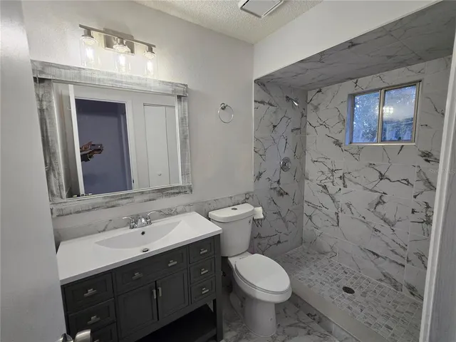 a bathroom with a sink toilet and shower