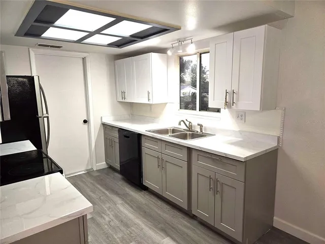 a kitchen with a sink stove and refrigerator