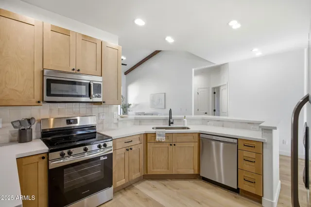 a kitchen with a sink stove and microwave