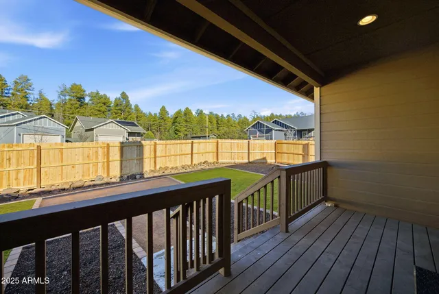 a view of a balcony with wooden floor and outdoor space
