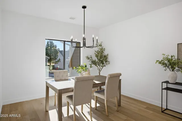 a view of a dining room with furniture window and wooden floor