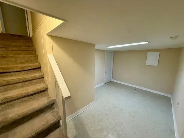 a view of an empty room with stairs