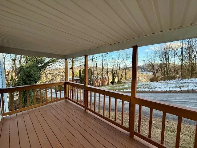 a view of a balcony with wooden floor
