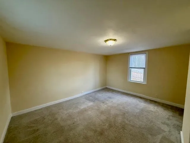 an empty room with a empty space and a window