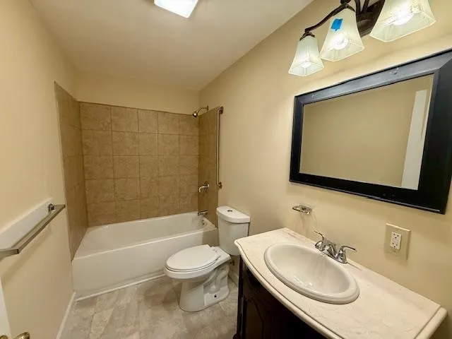 a bathroom with a sink a toilet and bathtub