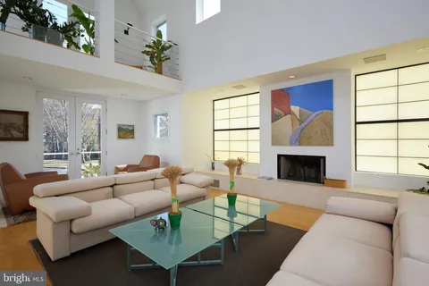 a living room with furniture a fireplace and a large window