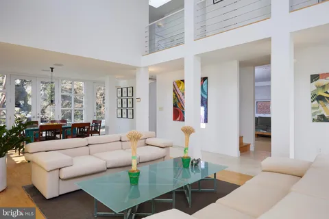 a living room with furniture and a large mirror