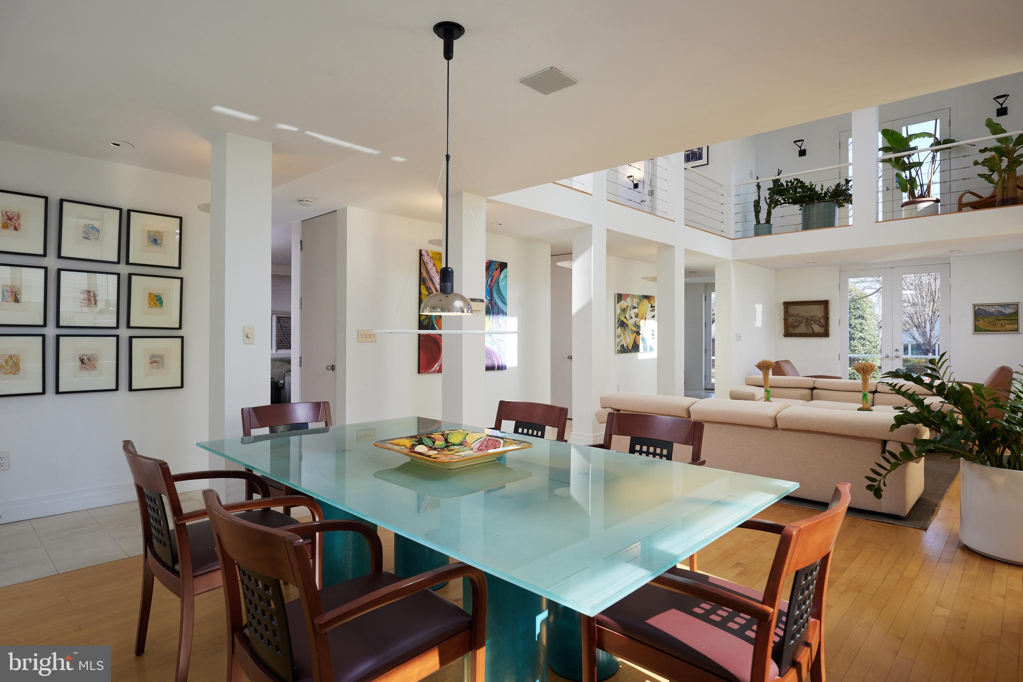 4527 Q Place Northwest Washington, DC 20007 - Photo 25 of 59 a view of a dining room and livingroom with furniture wooden floor a rug a painting and a chandelier