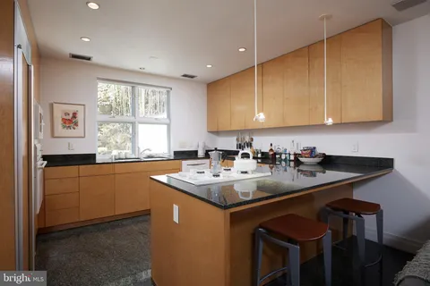 a kitchen with a sink cabinets and window