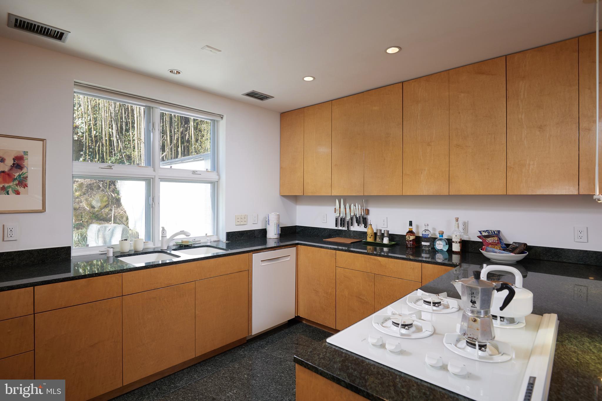 4527 Q Place Northwest Washington, DC 20007 - Photo 28 of 59 a kitchen with a sink a window and cabinets