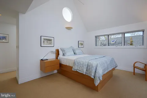 a spacious bedroom with a bed and a cabinets