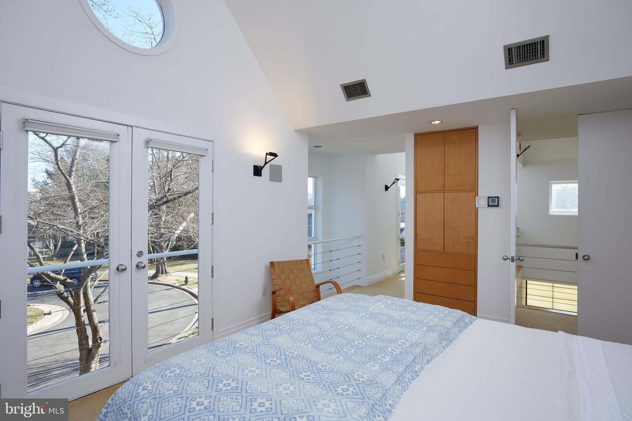 4527 Q Place Northwest Washington, DC 20007 - Photo 37 of 59 a bedroom with a bed and glass door