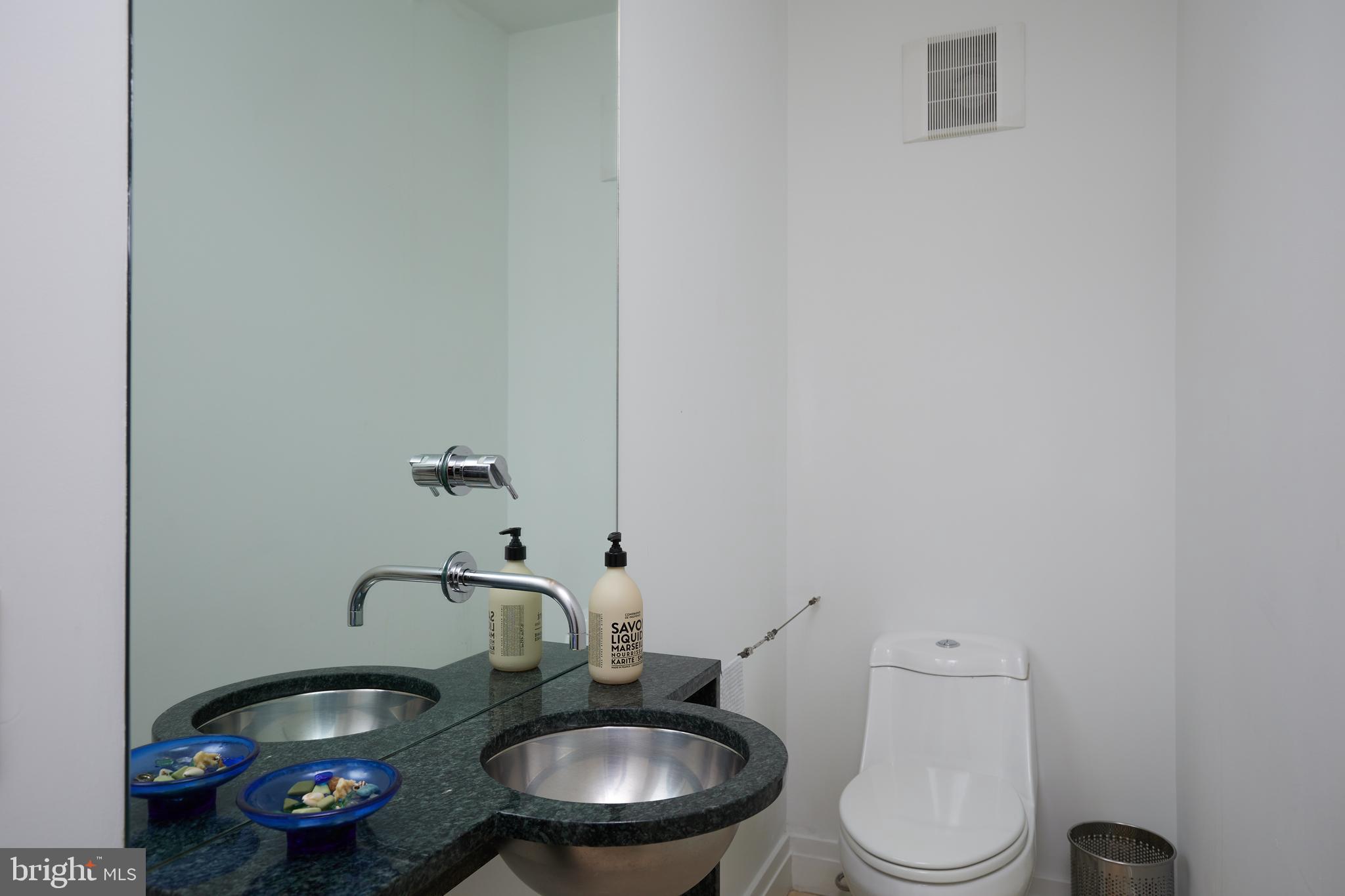 4527 Q Place Northwest Washington, DC 20007 - Photo 50 of 59 a bathroom with a toilet a sink and a mirror