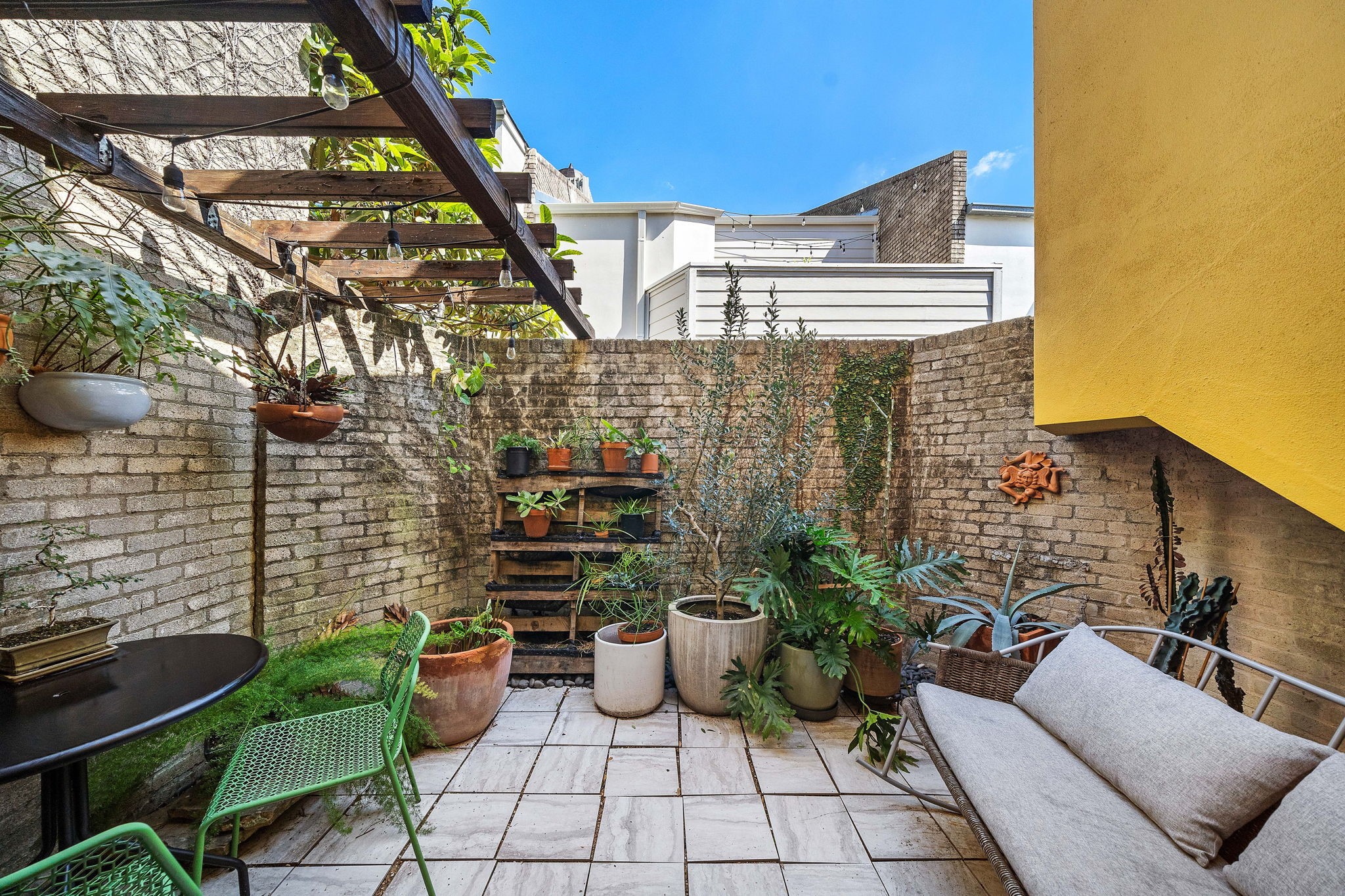 a view of a patio with couches and potted plants