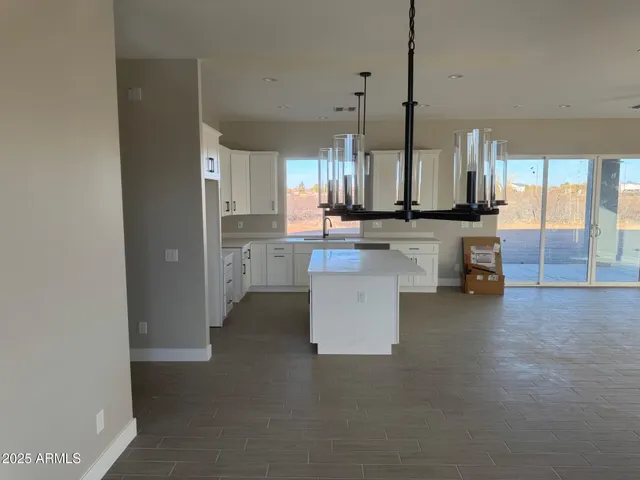 a kitchen with a sink and white cabinets