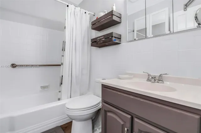 a bedroom with a bed and a cabinet