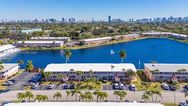 an aerial view of residential houses with outdoor space and swimming pool