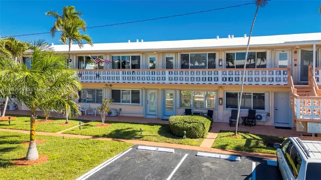 a view of a house with swimming pool and sitting area