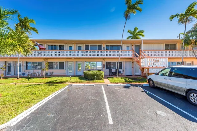 a front view of a house with swimming pool having outdoor seating