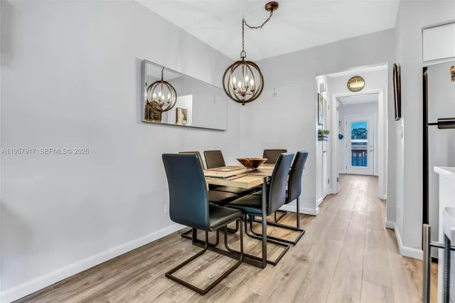 a view of a dining room with furniture wooden floor and a clock