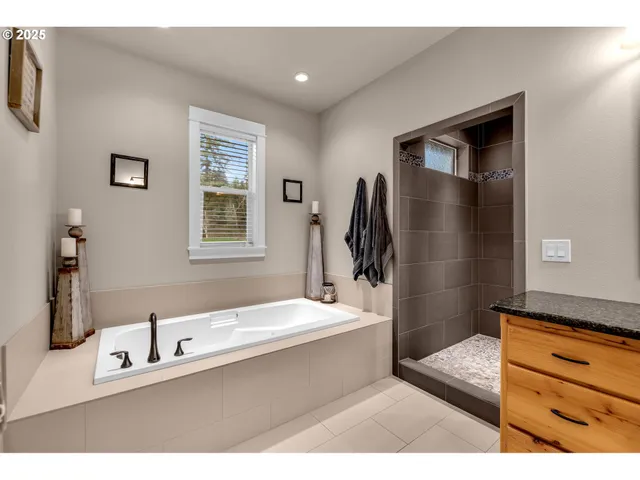 a bathroom with a sink tub and a mirror