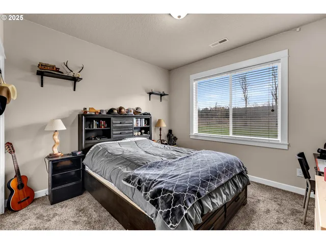 a bedroom with a bed next to a window