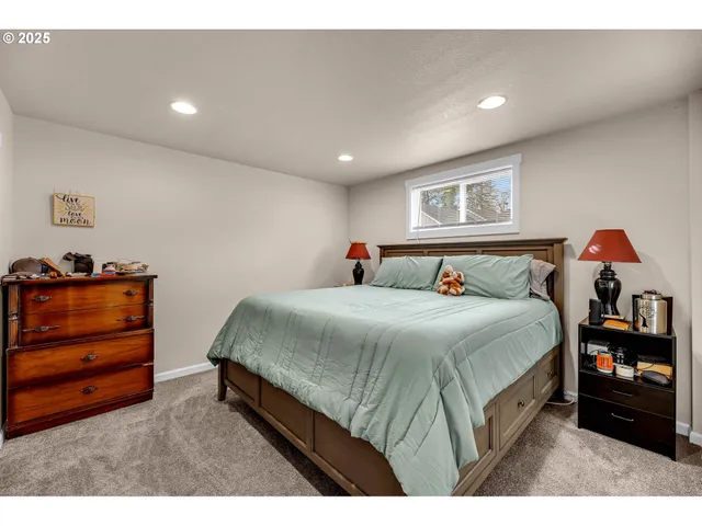 a spacious bedroom with a bed and a dresser