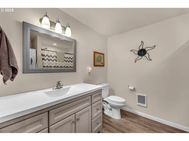 a bathroom with a sink a toilet and mirror