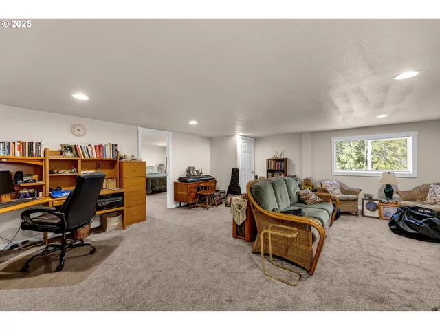 a living room with furniture a computer on the desk and chair
