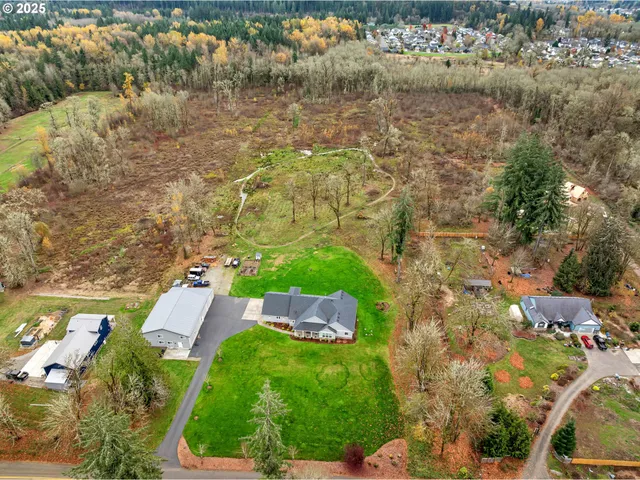 an aerial view of a house with a yard