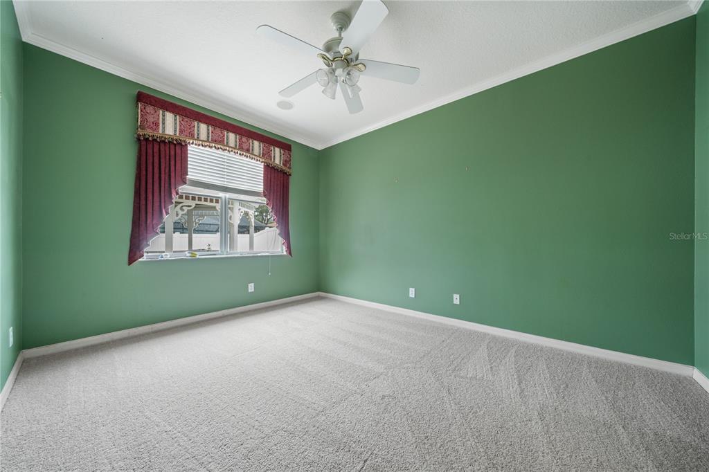 11610 Grove Arcade Drive Riverview, FL 33569 - Photo 20 of 35 an empty room with windows and a ceiling fan