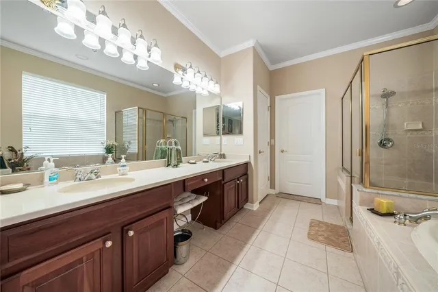 a spacious bathroom with a double vanity sink mirror and shower