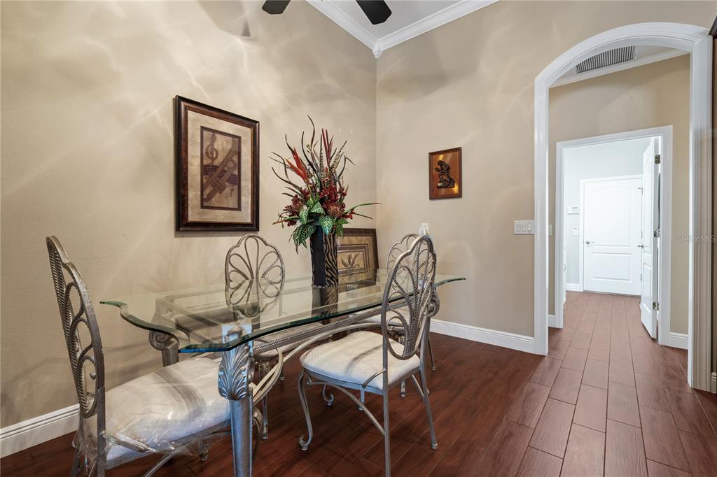 11610 Grove Arcade Drive Riverview, FL 33569 - Photo 10 of 35 a view of a dining room with furniture and wooden floor