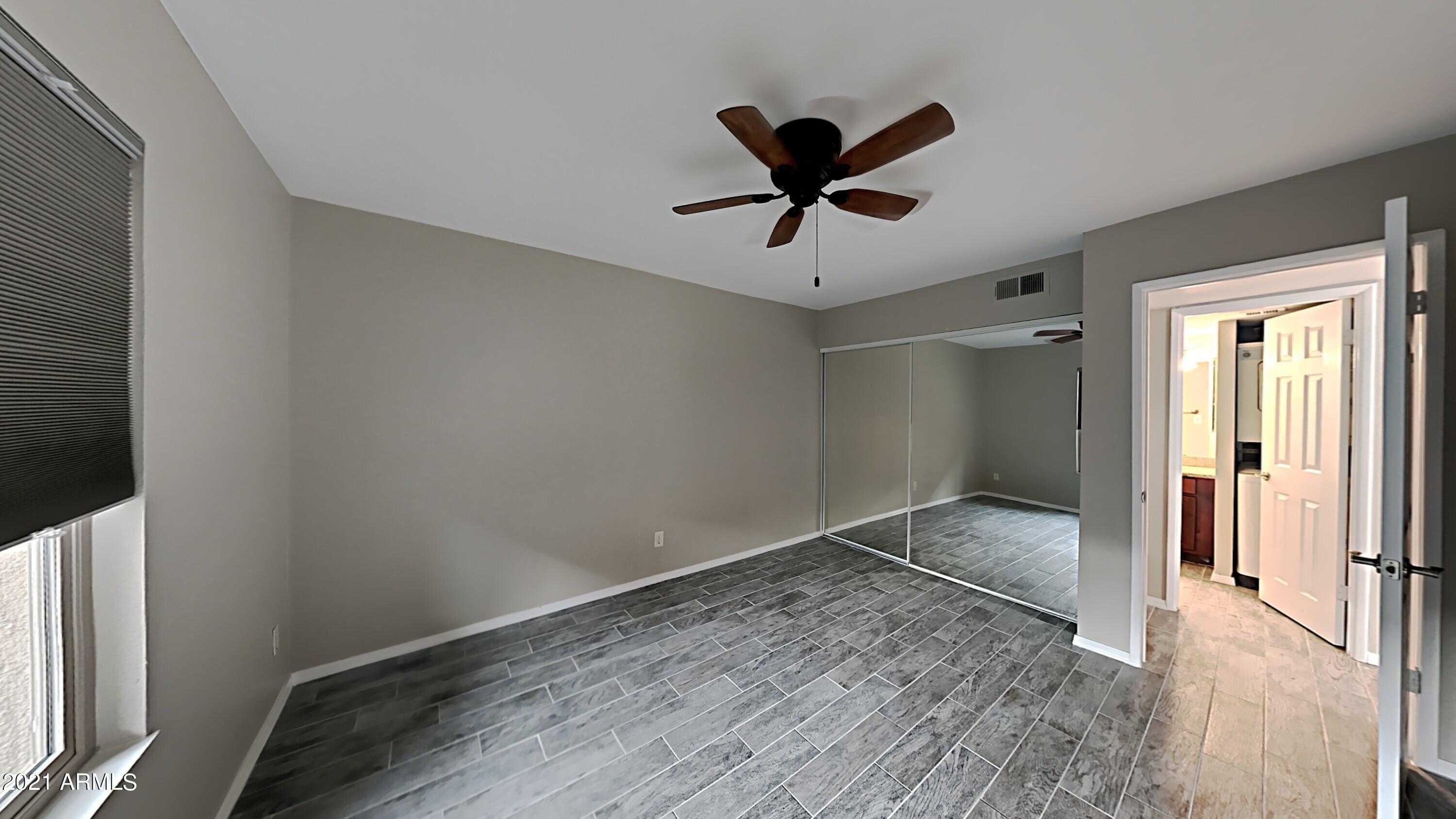3500 North Hayden Road, Unit 1703 Scottsdale, AZ 85251 - Photo 6 of 8 a view of empty room with wooden floor and fan