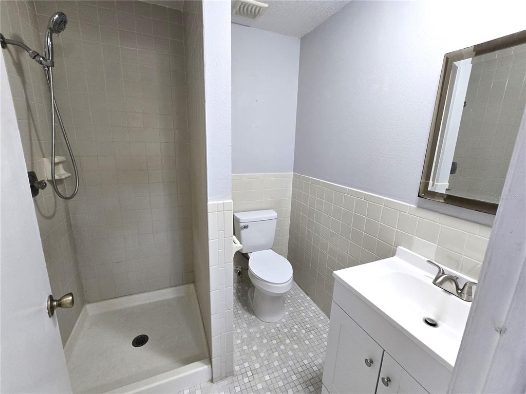 5422 Amy Lane New Port Richey, FL 34652 - Photo 15 of 25 a bathroom with a sink a toilet and shower