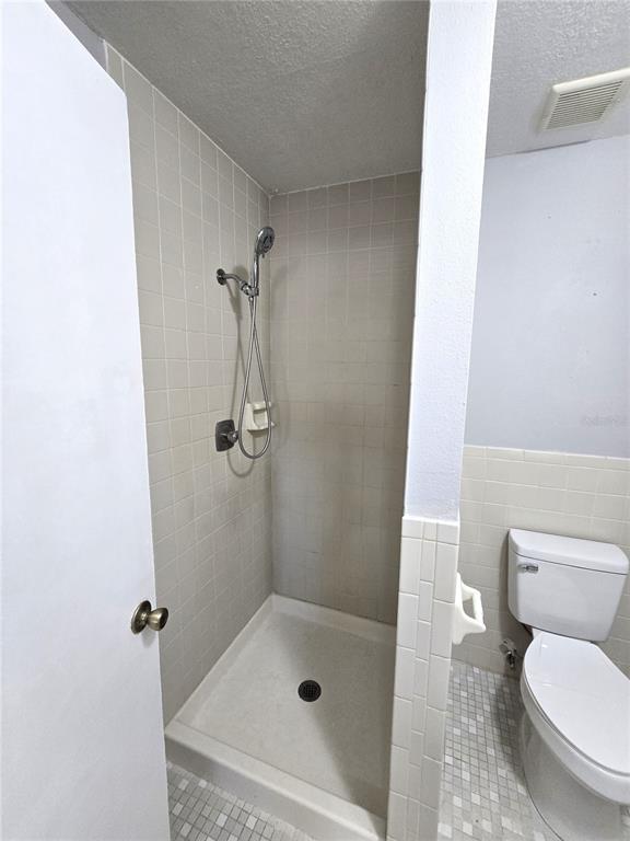 5422 Amy Lane New Port Richey, FL 34652 - Photo 16 of 25 a bathroom with a shower and toilet