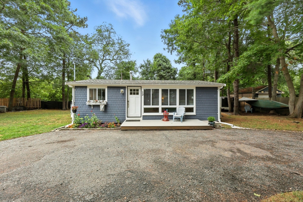 front view of a house with a patio and a yard