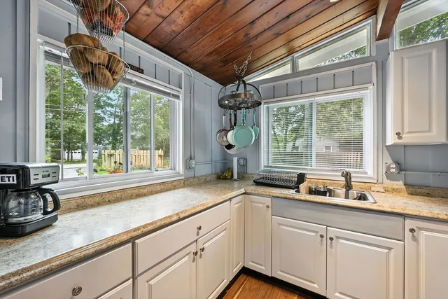 a kitchen with a sink and large window