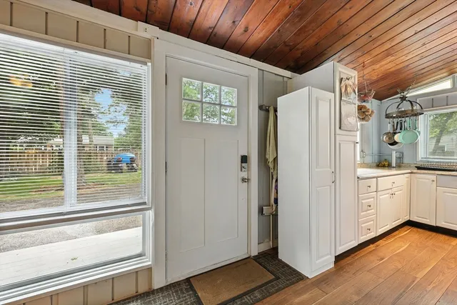 a view of a refrigerator in kitchen and wooden floor