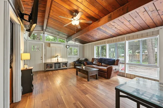 a living room with furniture and wooden floors