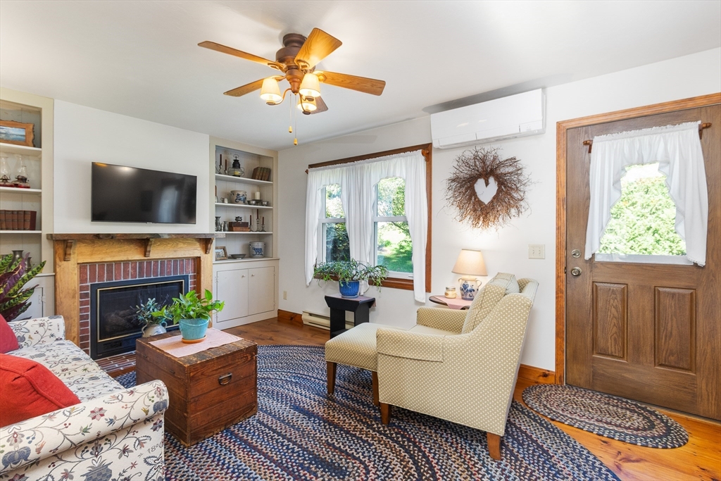 298 Torrey Road Southbridge, MA 01550 - Photo 12 of 40 a living room with furniture a fireplace and a flat screen tv