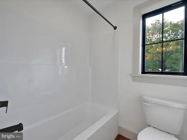 a bathroom with a toilet and a bathtub