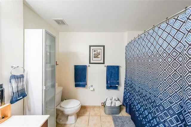 a white toilet sitting next to a bathroom sink