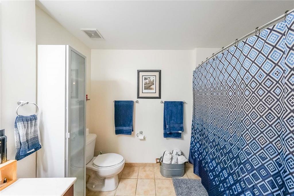 230 East Ponce De Leon Avenue, Unit 327 Decatur, GA 30030 - Photo 13 of 24 a white toilet sitting next to a bathroom sink