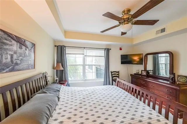 a bedroom with furniture a bed and a flat screen tv