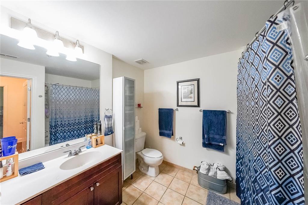 230 East Ponce De Leon Avenue, Unit 327 Decatur, GA 30030 - Photo 15 of 24 a bathroom with a sink a toilet and shower