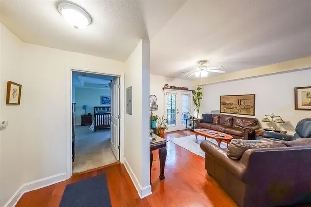 a living room with furniture and a wooden floor