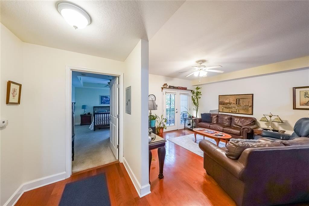 230 East Ponce De Leon Avenue, Unit 327 Decatur, GA 30030 - Photo 16 of 24 a living room with furniture and a wooden floor